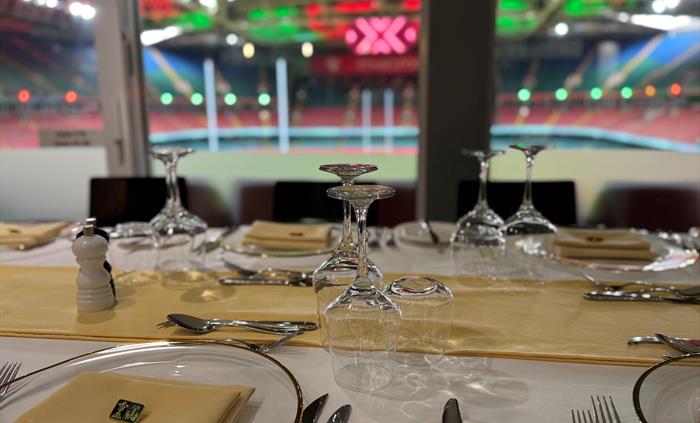 The South Stand Lounge overlooking the Principality Stadium pitch, with stylish seating and panoramic views, set up for a premium matchday hospitality